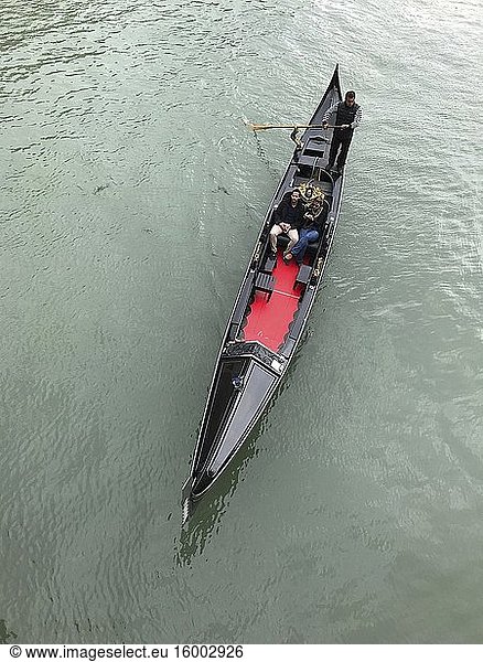 Black Gondola in Grand canal  seen from Ponte di Rialto  Rialto bridge  in Venice. Photo: Andr? Maslennikov.