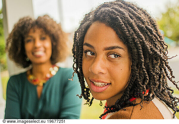 Black mother and daughter portraits on porch