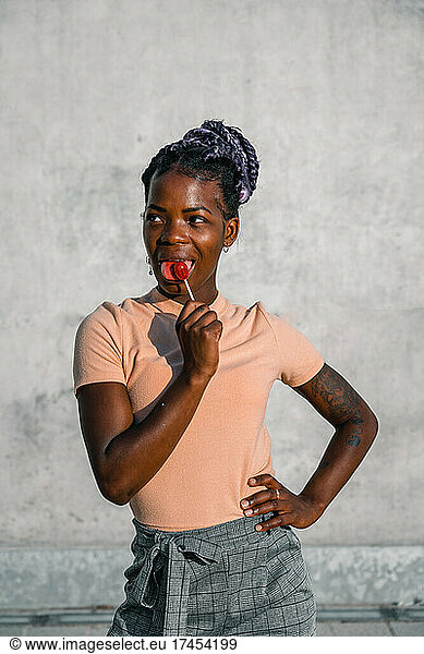 black woman posing proud with a lollipop