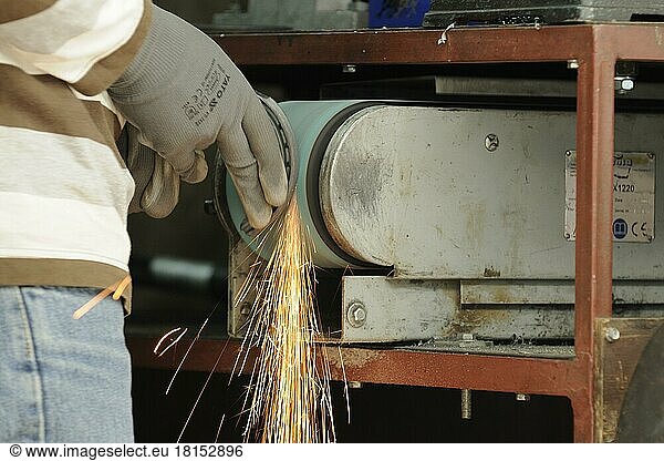 Blacksmith at work  grinding horseshoes