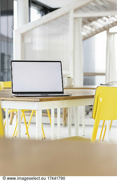 Blank screen laptop kept on desk in office