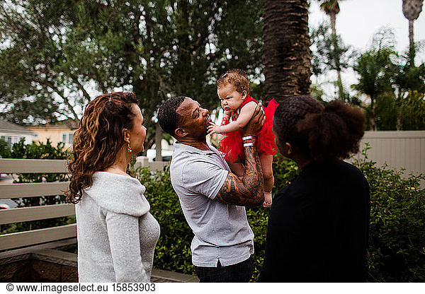 Blended Biracial Family Smiling at Baby