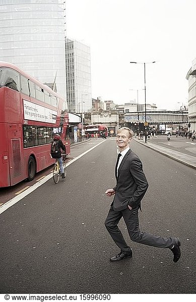 Blissful businessman crossing street in London  UK.