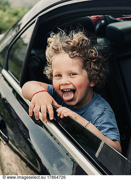 blond boy looking out of car window