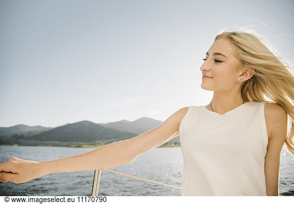 Blond teenage girl on a sail boat.