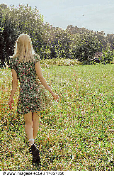 Blond woman at the nature back
