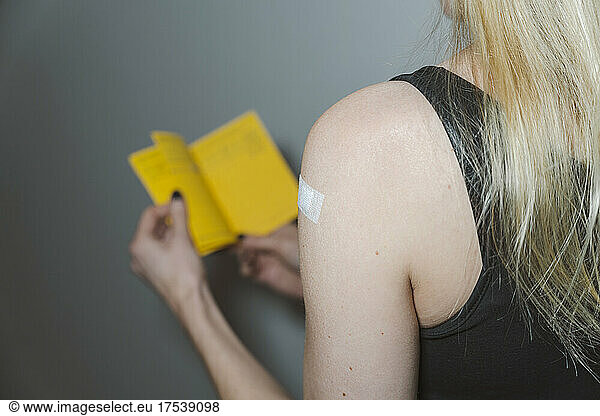 Blond woman with adhesive bandage on arm