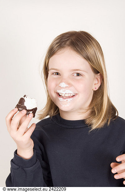 Blonde girl (8-9) holding a chocolate marshmallow  portrait