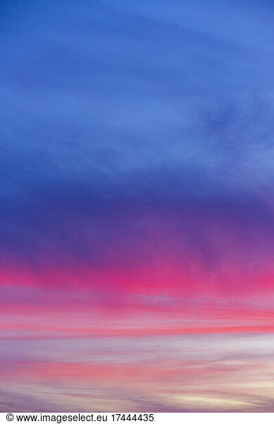 Blue and pink clouds at moody dusk