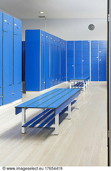 Blue bench in empty locker room at gym
