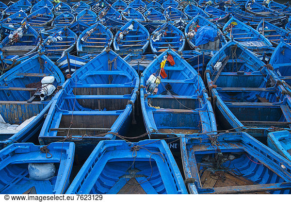 Blue boats docked in harbor