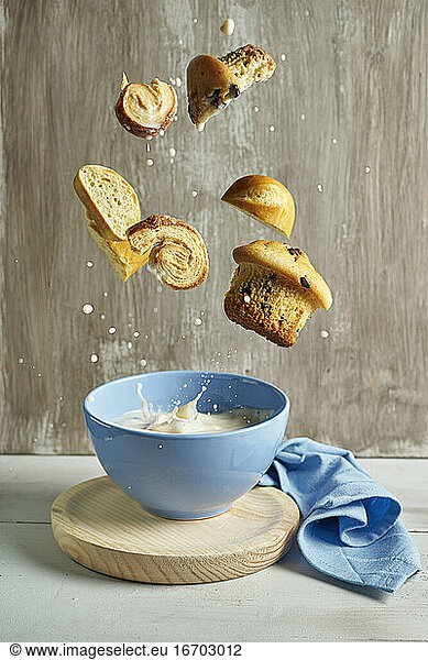 blue bowl with with splashes of milk flying chocolate muffins  p