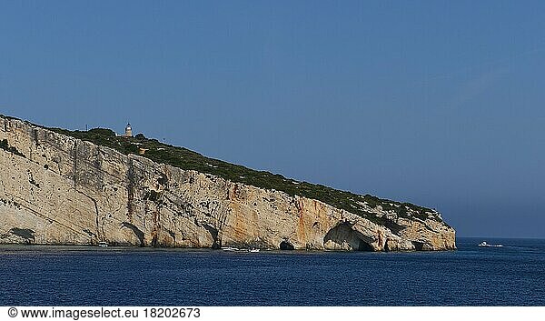 Blue Caves  morning light  boat  lighthouse  rocky coast  blue cloudless sky  northeast coast  Zakynthos Island  Ionian Islands  Greece  Europe