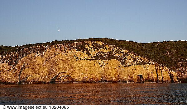 Blue Caves  morning light  moon small  rocky coast  northeast coast  blue cloudless sky  Zakynthos Island  Ionian Islands  Greece  Europe