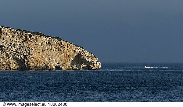 Blue Caves  morning light  rocky coast  boat  blue cloudless sky  northeast coast  Zakynthos Island  Ionian Islands  Greece  Europe