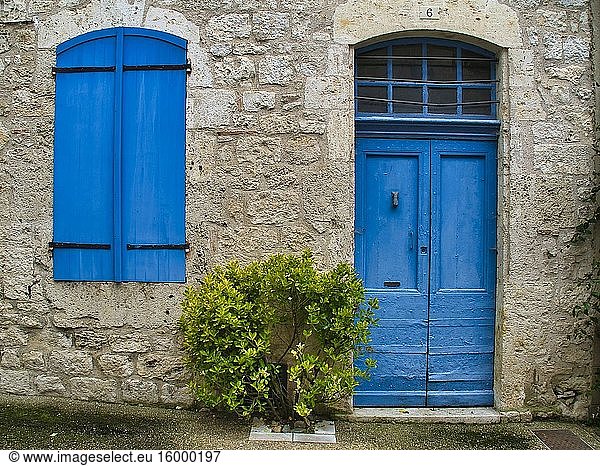 Blue door and shutters in Rue de la Garrigue  Lauzerte  Tarn-et-Garonne department  Occitanie  France.