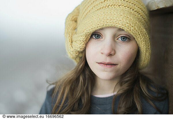Blue-eyed girl in yellow knit hat