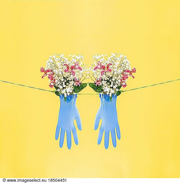 Blue gloves with flowers. Eco-friendly concept or Cleaning concept.