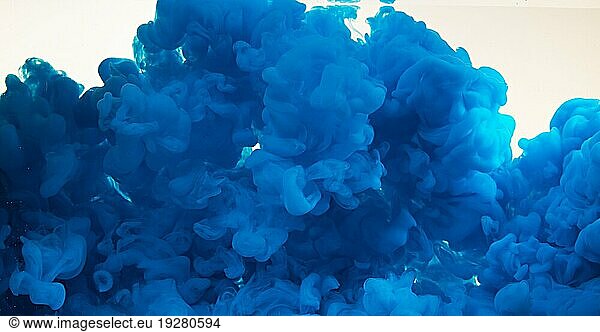 Blue Ink entering Water against white Background