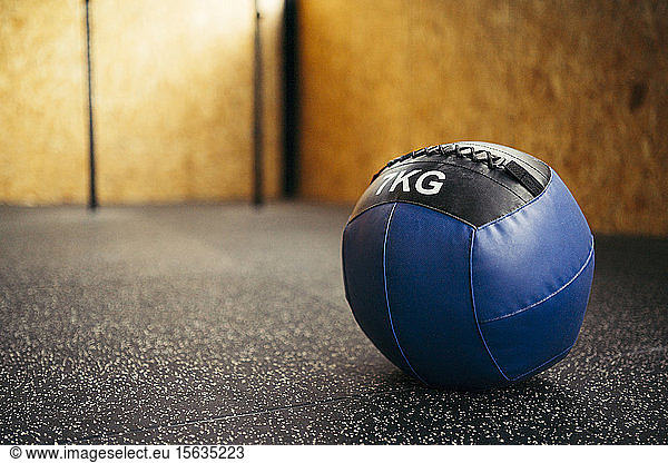 Blue medicine ball in a corner of a gym
