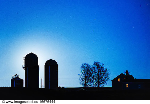 Blue Moonrise silhouettes Vermont Farm house and silos