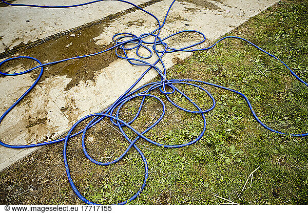Blue Plastic Hose Laying On The Ground