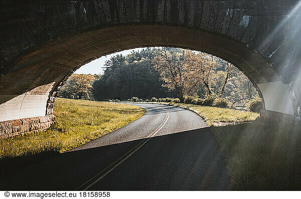 Blue Ridge Parkway curves under a stone arch bridge  Virginia