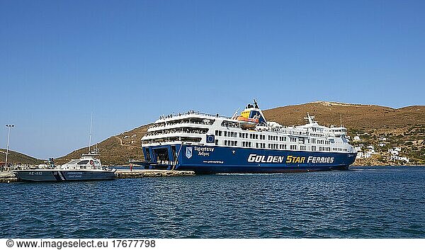 Blue sky  blue and white ferry at anchor  Golden Star Ferries  passengers on deck  cloudless  blue sea  Gavrio  Andros Island  Cyclades  Greece  Europe