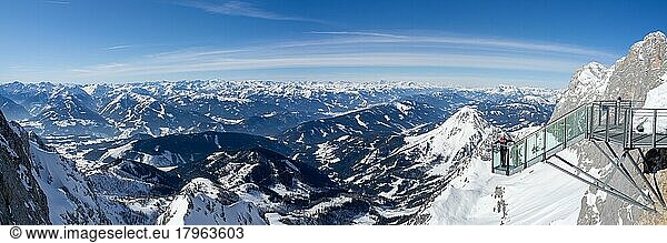 Blue sky over alpine winter landscape  tourist standing on the stairs to nowhere  snow-covered alpine peaks  Dachstein massif  Styria  Austria  Europe