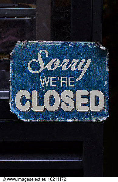 Blue weathered closed sign