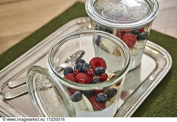 Blueberry and raspberry in jar on table