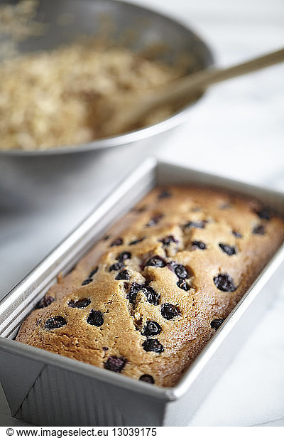 Blueberry bread in container on marble counter