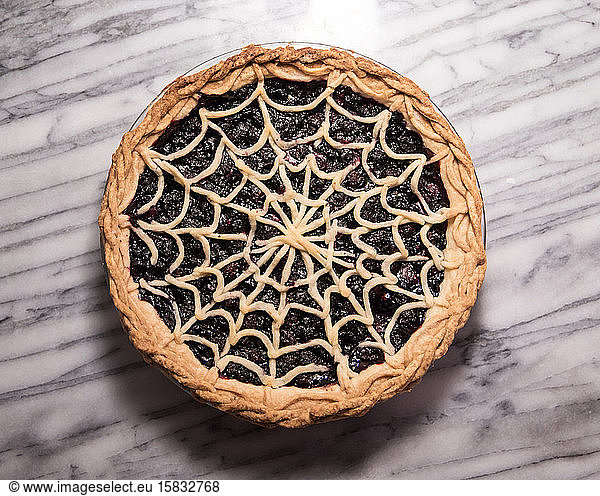 Blueberry Pie with Spiderweb Lattice Crust on Marble Pastry Board