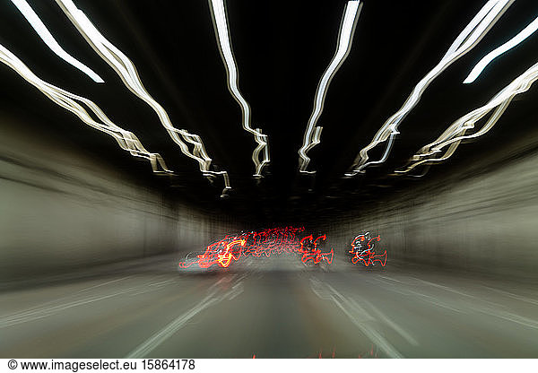 Blurred car taillights on roadway in tunnel in San Francisco Ca