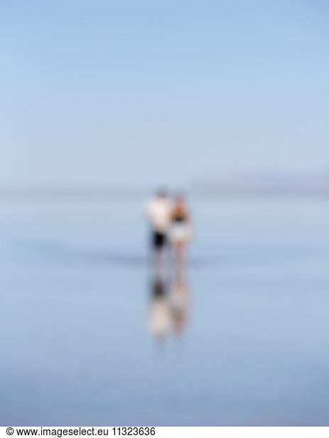 Blurred focus image of two people standing on flooded Bonneville Salt Flats  Utah