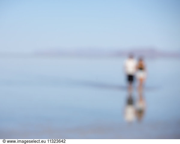 Blurred focus image of two people standing on flooded Bonneville Salt Flats  Utah
