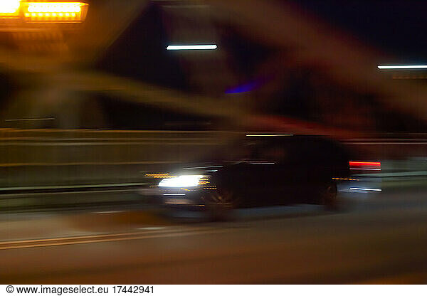 Blurred motion of car driving at night