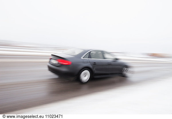 Blurred motion of car on road during winter