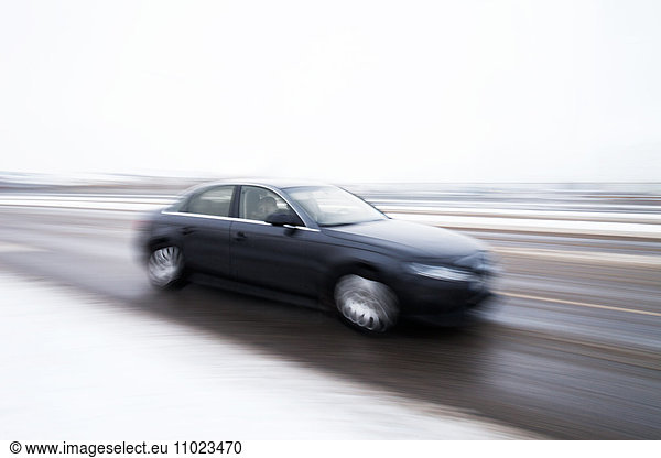 Blurred motion of car on street during winter