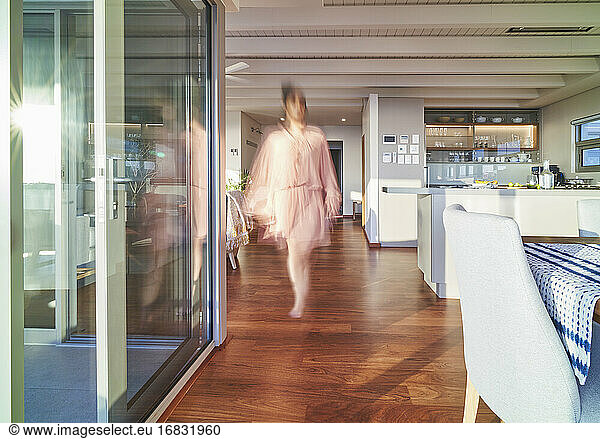 Blurred woman walking in luxury home showcase interior