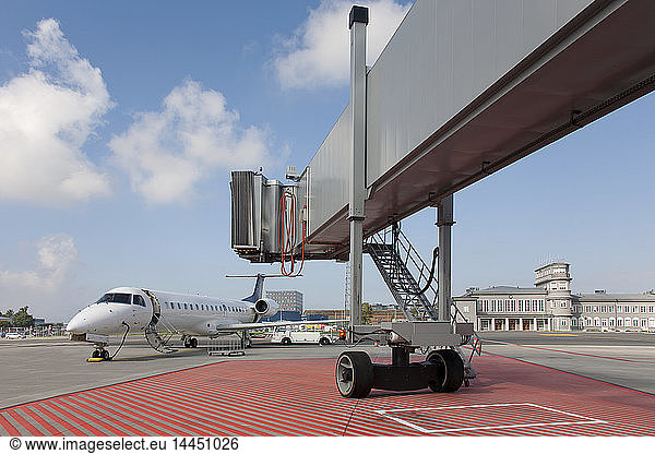 Boarding Bridge Leading to a Parked Plane