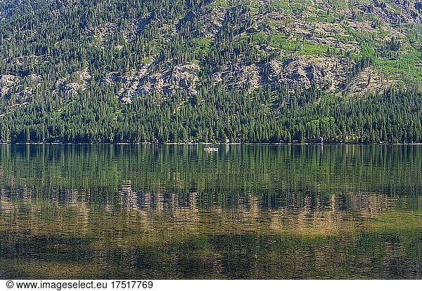 Boat floating on a lake in the mountains on a summer day