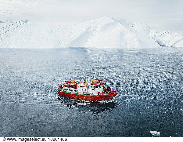 boat near big icebergs from aerial point of view