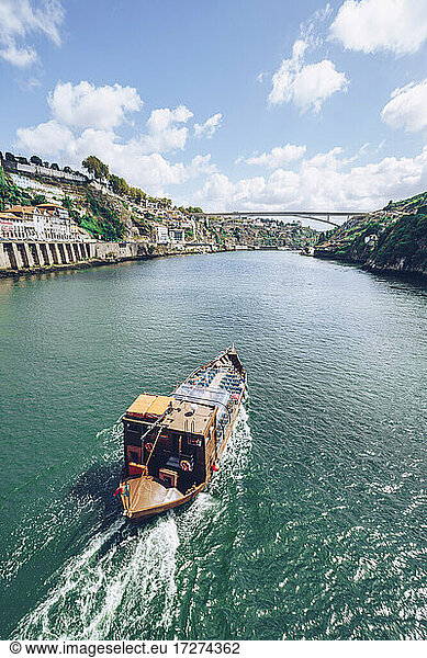 Boat sailing in Douro River against sky  Porto  Portugal