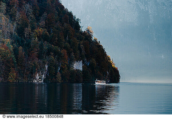 boat through the blue waters of Lake Königsee surrounded by mountains