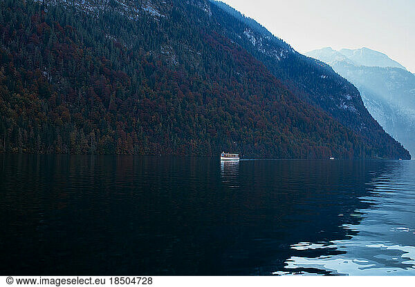 boats sail on the blue waters of an alpine lake surrounded by mountain