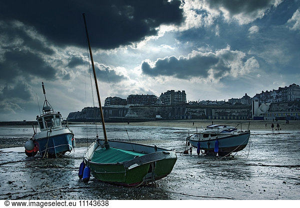 Boats stranded on urban beach  Broad Stairs  Isle of Thanet  United Kingdom