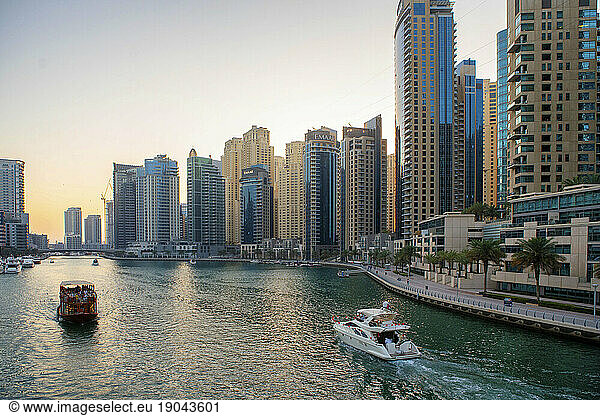 Boats travel through the Dubai Marina in the United Arab Emirates