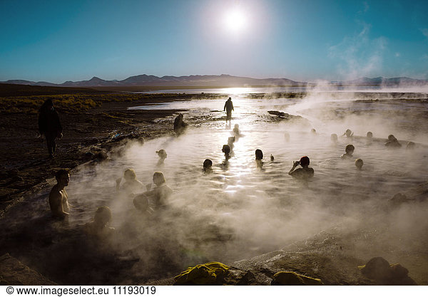 Bolivia  Altiplano  People enjoying sunrise in the hot waters near Salar de Uyuni
