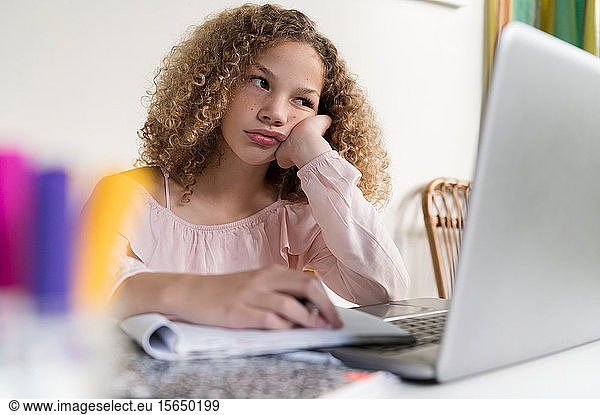 Bored girl using laptop